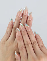 Model wearing Aqua Gem nails — Naillover Singapore press on nails with nude base and shimmering blue crystals.